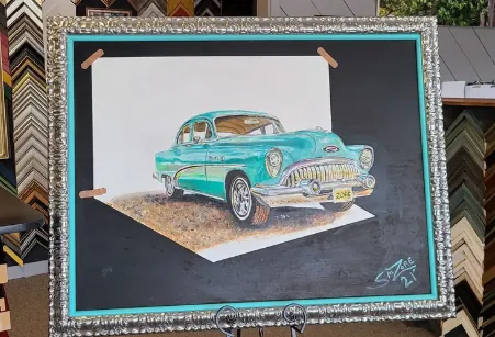 Colored-pencil drawing of a turquoise 1953 Buick, float-mounted on black with a turquoise accent mat in an ornate silver frame