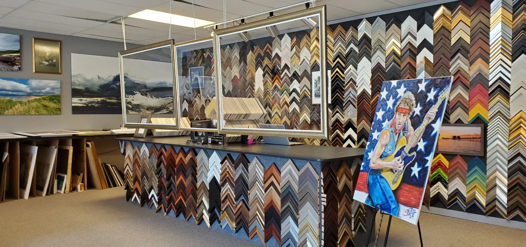 The moulding wall inside Luxe Frame Gallery, hundreds of sample corners arranged by tone